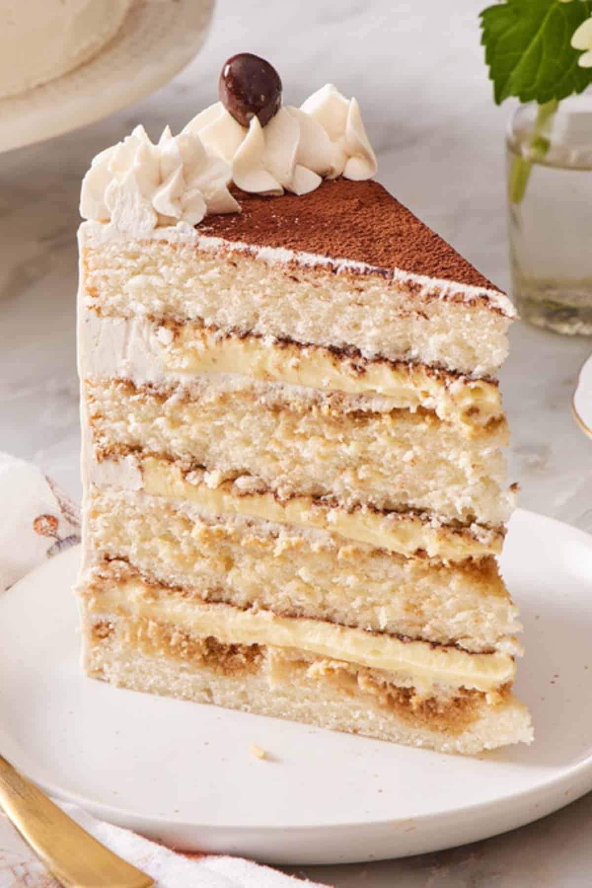 A slice of tiramisu cake on a small plate.